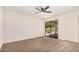 This is a bedroom with sliding glass doors that lead to a patio and a ceiling fan with a light at 1955 Leisure World --, Mesa, AZ 85206