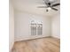 An empty bedroom with a ceiling fan and arched window is ready for its next occupant at 1955 Leisure World --, Mesa, AZ 85206