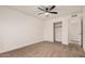 An empty bedroom has a ceiling fan, neutral carpet, and a closet with sliding doors at 1955 Leisure World --, Mesa, AZ 85206