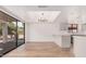 Open dining area with sliding glass doors to the patio and modern light fixture at 1955 Leisure World --, Mesa, AZ 85206