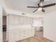 Well-lit kitchen featuring new gray cabinets with gold hardware and a modern ceiling fan at 1955 Leisure World --, Mesa, AZ 85206