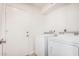 Bright laundry room with a white washer and dryer and convenient access to an exterior door at 1955 Leisure World --, Mesa, AZ 85206