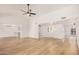 Open-concept living room featuring bright white walls, wood-look floors, and natural light at 1955 Leisure World --, Mesa, AZ 85206