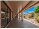 Relaxing covered patio perfect for outdoor entertaining, with a view of the landscaped backyard at 1955 Leisure World --, Mesa, AZ 85206