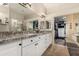 Bright bathroom featuring double sinks, granite countertop, and a luxurious walk-in closet at 1963 E Monterey St, Chandler, AZ 85225