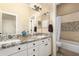 A bright bathroom with a double sink vanity, granite countertop, and a shower/tub combination separated by a shower curtain at 1963 E Monterey St, Chandler, AZ 85225