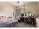A charming bedroom with a bed, a desk area, and a decorative vanity that provides a comfortable and stylish living space at 1963 E Monterey St, Chandler, AZ 85225