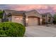 A three-car garage framed by lush green landscaping and a desert-style yard at 1963 E Monterey St, Chandler, AZ 85225