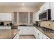 Beautiful kitchen with granite counters, white cabinets, and stainless steel appliances at 1963 E Monterey St, Chandler, AZ 85225