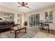 Open-concept living room featuring a ceiling fan, glass sliding doors, and a decorative rug at 1963 E Monterey St, Chandler, AZ 85225