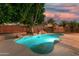 Inviting backyard pool with rock accents and landscaping under a picturesque sky at 1963 E Monterey St, Chandler, AZ 85225