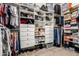 A beautifully organized walk-in closet with custom white shelving, drawers, rods, and ample storage for clothes and accessories at 1963 E Monterey St, Chandler, AZ 85225