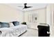 Bedroom with neutral walls, window with white shutters, and daybed with blue accent pillows at 215 W Mountain Sage Dr, Phoenix, AZ 85045