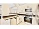 Bright kitchen features stainless steel appliances, dark countertops, and white cabinetry at 215 W Mountain Sage Dr, Phoenix, AZ 85045