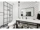 Modern bathroom features black and white tiling, walk-in shower, and sleek sink with storage at 222 E Danbury Rd, Phoenix, AZ 85022