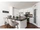 Modern kitchen features a marble island, stainless steel appliances, and ample cabinet space, perfect for cooking enthusiasts at 222 E Danbury Rd, Phoenix, AZ 85022
