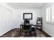 Well-lit office space with a large desk, chair, shelving, and a cozy rug, perfect for productivity at 222 E Danbury Rd, Phoenix, AZ 85022