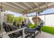 Inviting covered patio featuring stylish seating, tables, ambient lighting, and a view of the lush backyard at 222 E Danbury Rd, Phoenix, AZ 85022