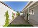 Side yard featuring a graveled walkway, flowering bushes, a small patch of grass and the home's siding at 222 E Danbury Rd, Phoenix, AZ 85022