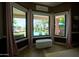 Inviting backyard view featuring a pristine pool and covered seating area, as seen through large windows at 22364 N 59Th Ln, Glendale, AZ 85310