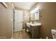 Charming bathroom featuring a farmhouse sink, rustic vanity, and modern lighting at 22364 N 59Th Ln, Glendale, AZ 85310