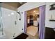 Elegant bathroom featuring a glass shower and walk-in closet with custom shelving at 22364 N 59Th Ln, Glendale, AZ 85310