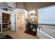 Bathroom boasts a soaking tub, glass block window, and convenient toilet room at 22364 N 59Th Ln, Glendale, AZ 85310