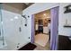 Elegant bathroom featuring a glass shower and walk-in closet with custom shelving at 22364 N 59Th Ln, Glendale, AZ 85310