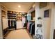 Spacious walk-in closet features custom shelving, ample hanging space, and woven storage baskets at 22364 N 59Th Ln, Glendale, AZ 85310