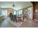 Dining room with hardwood floors, neutral walls, a wooden table with upholstered chairs, and large windows at 22364 N 59Th Ln, Glendale, AZ 85310