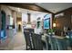 Open concept floor plan with a dining room that features hardwood floors, high ceilings, and a large window at 22364 N 59Th Ln, Glendale, AZ 85310