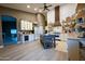 Bright, modern kitchen featuring white cabinets, butcher block countertops, stainless steel appliances, and a center island at 22364 N 59Th Ln, Glendale, AZ 85310