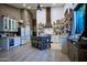Modern kitchen with white cabinets, butcher block countertops, wooden accents, a central island, and stainless steel appliances at 22364 N 59Th Ln, Glendale, AZ 85310