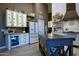 Well-lit kitchen with white cabinets, butcher block countertops, stainless steel appliances, and a central island at 22364 N 59Th Ln, Glendale, AZ 85310