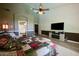 Spacious main bedroom with a high ceiling, neutral walls, hardwood floors, and a large TV at 22364 N 59Th Ln, Glendale, AZ 85310