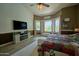 Serene bedroom featuring large windows overlooking the pool and cozy decor at 22364 N 59Th Ln, Glendale, AZ 85310