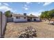 Expansive backyard featuring a rock feature, white exterior, covered patio, providing a serene outdoor living space at 224 N 58Th St, Mesa, AZ 85205