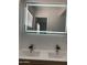 Bathroom vanity with double sinks, modern faucets, and illuminated mirror at 224 N 58Th St, Mesa, AZ 85205