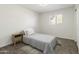 Neutral bedroom with a gray bed, small wood end table, and window with light at 224 N 58Th St, Mesa, AZ 85205