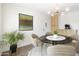 Bright dining area features modern lighting and a glass table with seating for four at 224 N 58Th St, Mesa, AZ 85205
