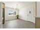 Inviting dining area features modern light fixture, neutral paint, and view to outdoors at 224 N 58Th St, Mesa, AZ 85205
