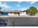 Charming single-story home with a blue garage door, desert landscaping, and inviting curb appeal at 224 N 58Th St, Mesa, AZ 85205