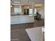 Bright, open kitchen features light wood cabinets, stainless appliances, and a center island with white countertop at 224 N 58Th St, Mesa, AZ 85205