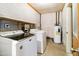 Functional laundry room with a washer, dryer, water heater, and ample space for chores at 224 N 58Th St, Mesa, AZ 85205