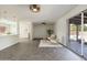 Open-concept living room with a large sliding glass door, sleek tile flooring, and contemporary decor at 224 N 58Th St, Mesa, AZ 85205