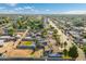 Expansive aerial view showcasing the property's surroundings, including neighborhood homes, mature trees, and vibrant community at 2261 E Decatur St, Mesa, AZ 85213