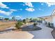 Serene backyard with a winding walkway, custom patio and lush landscaping for outdoor entertaining and relaxing at 2261 E Decatur St, Mesa, AZ 85213