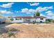 Spacious backyard with patio, desert landscaping, and white exterior at 2261 E Decatur St, Mesa, AZ 85213