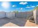View of backyard with cinder block fencing, metal storage container, ladder, wheelbarrow, and gravel ground cover at 2261 E Decatur St, Mesa, AZ 85213