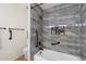 Modern bathroom featuring gray tile, a niche, and a white bathtub at 2261 E Decatur St, Mesa, AZ 85213
